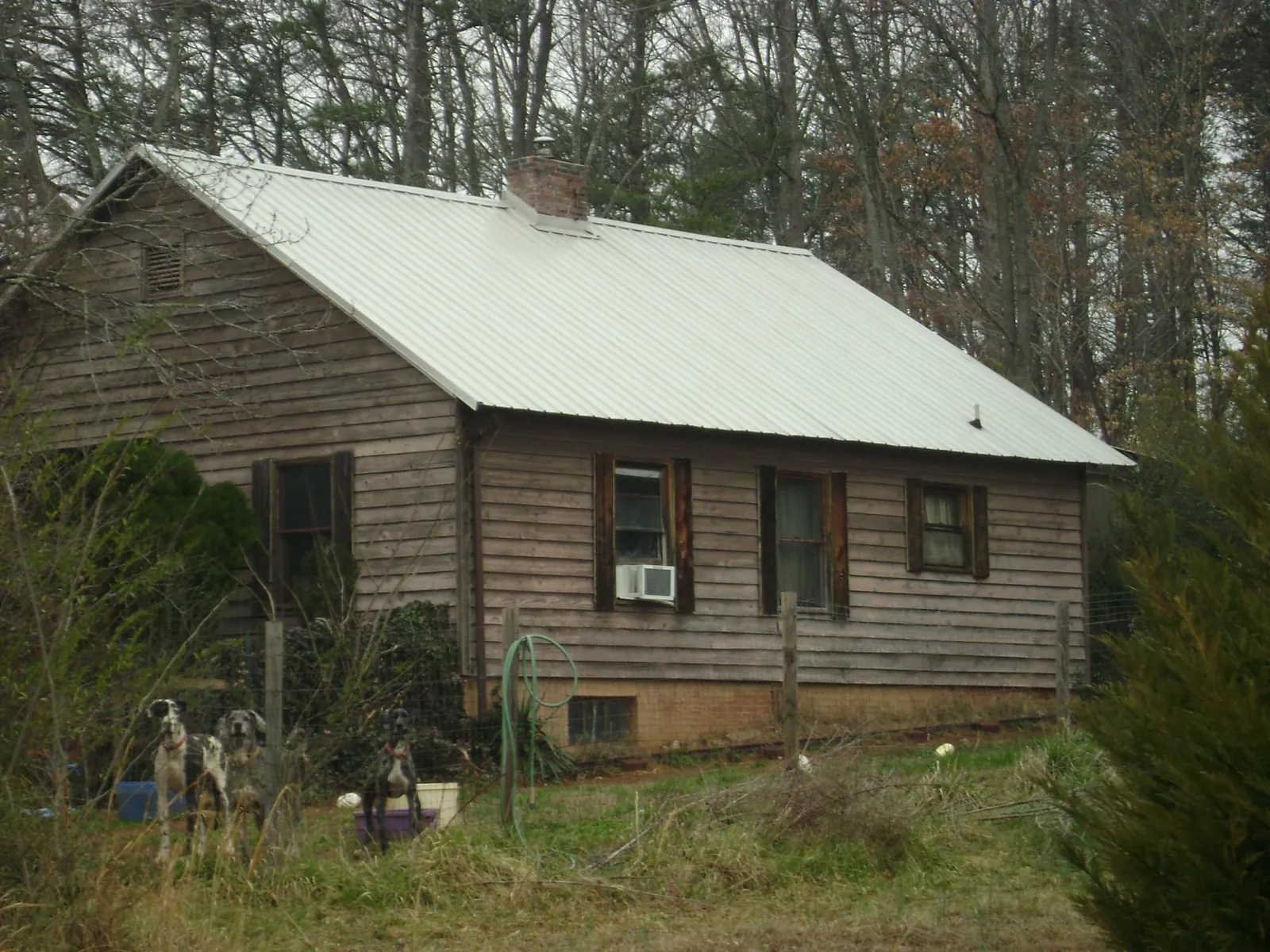 White metal roof on an old wood sided farmhouse, from a Metal Roof Installation job in Jonesborough